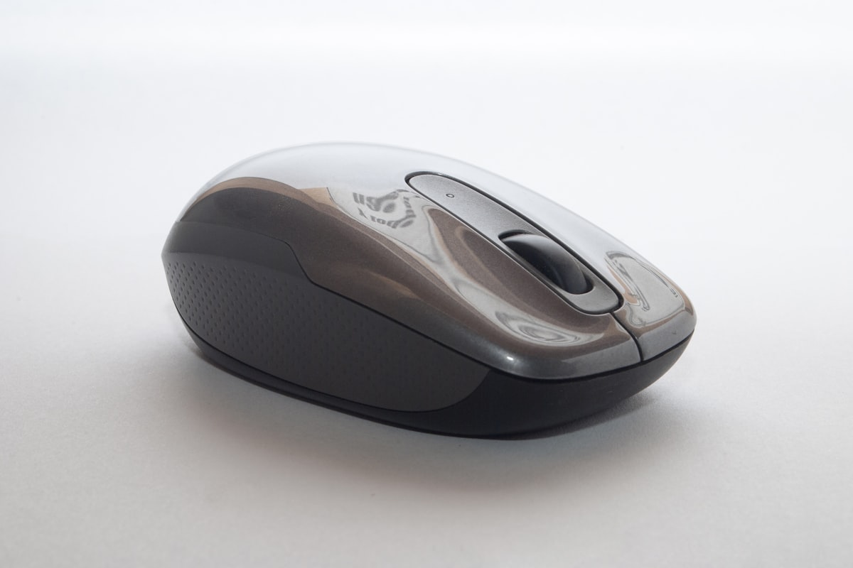 Side-by-side comparison of AI mouse and traditional productivity mouse on a dark desk