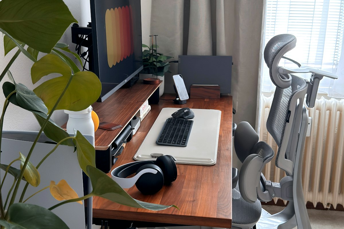 Modern desk setup with laptop displaying AI productivity tool interface showing task list and calendar