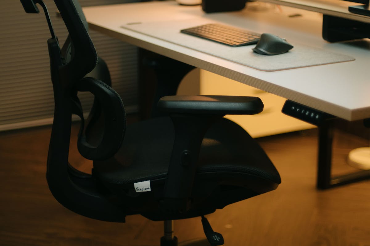Close-up of modern ergonomic office chair with mesh backrest and adjustable armrests