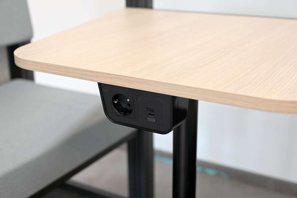 Desk with an integrated power outlet and USB ports built into the surface