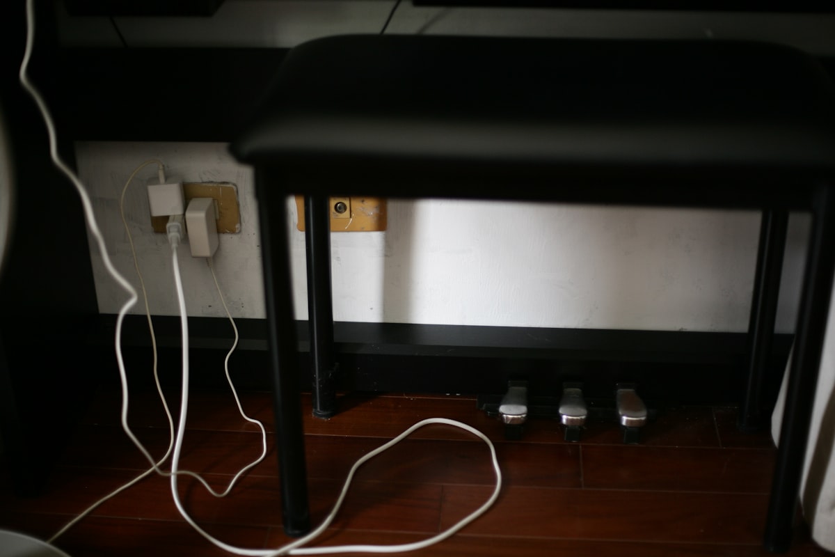Tangle of power and data cables trailing across a wooden floor