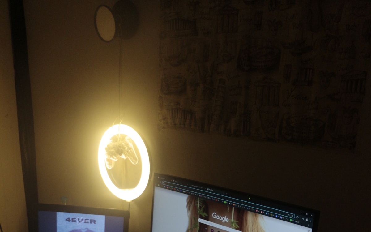 Clean dark-themed desk workspace with monitors at eye level
