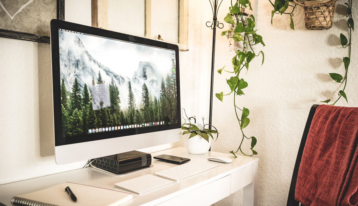 Premium Thunderbolt 5 docking station on a dark desk with a single USB-C cable connecting to a laptop — clean minimalist workspace