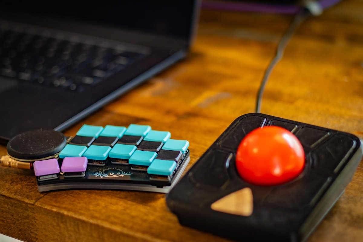 Split ergonomic keyboard on a desk, two halves positioned shoulder-width apart