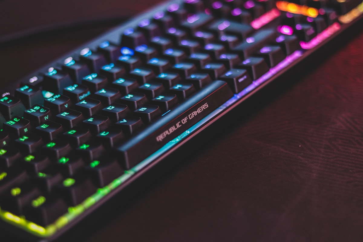 Backlit mechanical keyboard with LED lighting on a dark desk