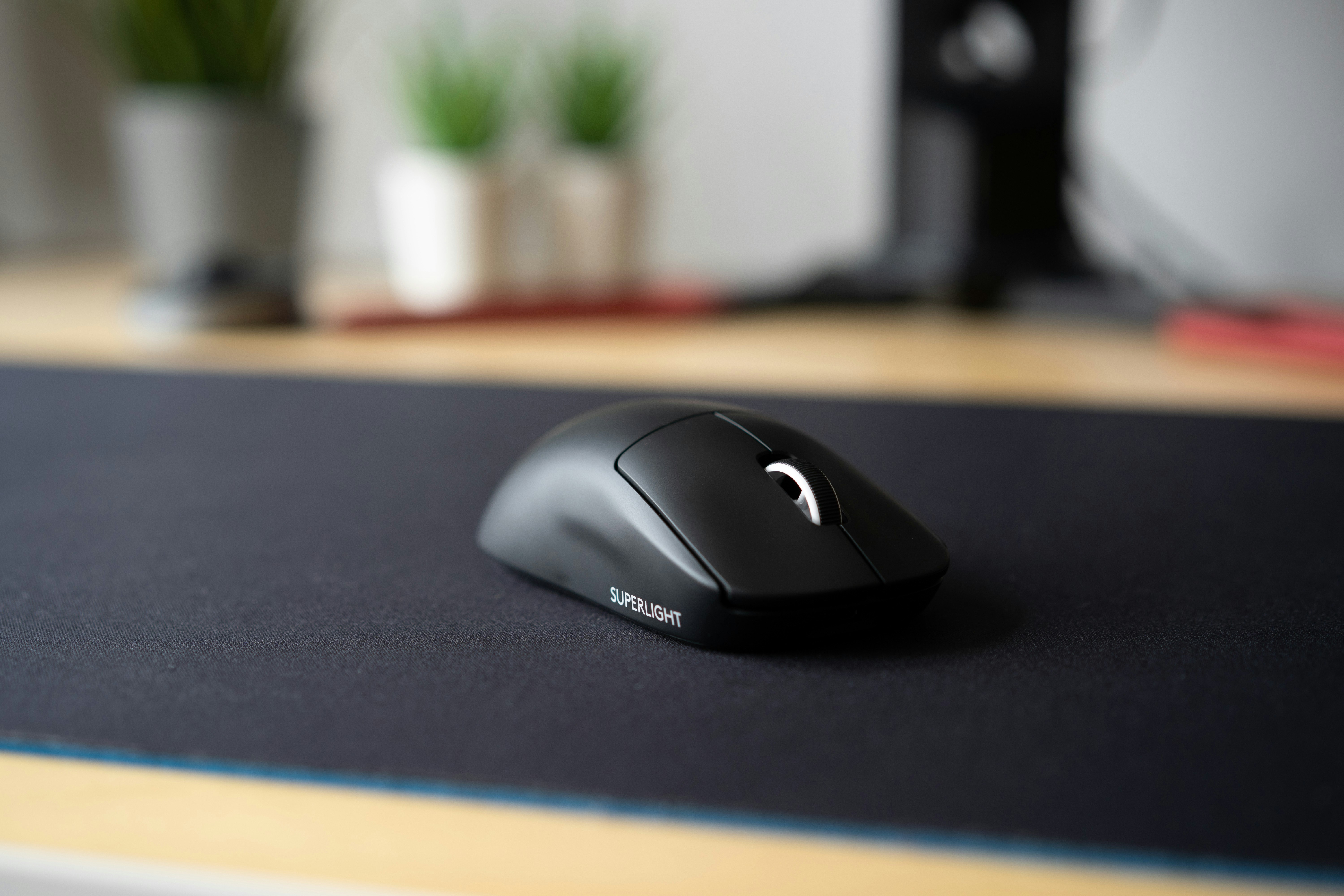 Close-up of a vertical ergonomic mouse in hand showing the natural handshake grip angle
