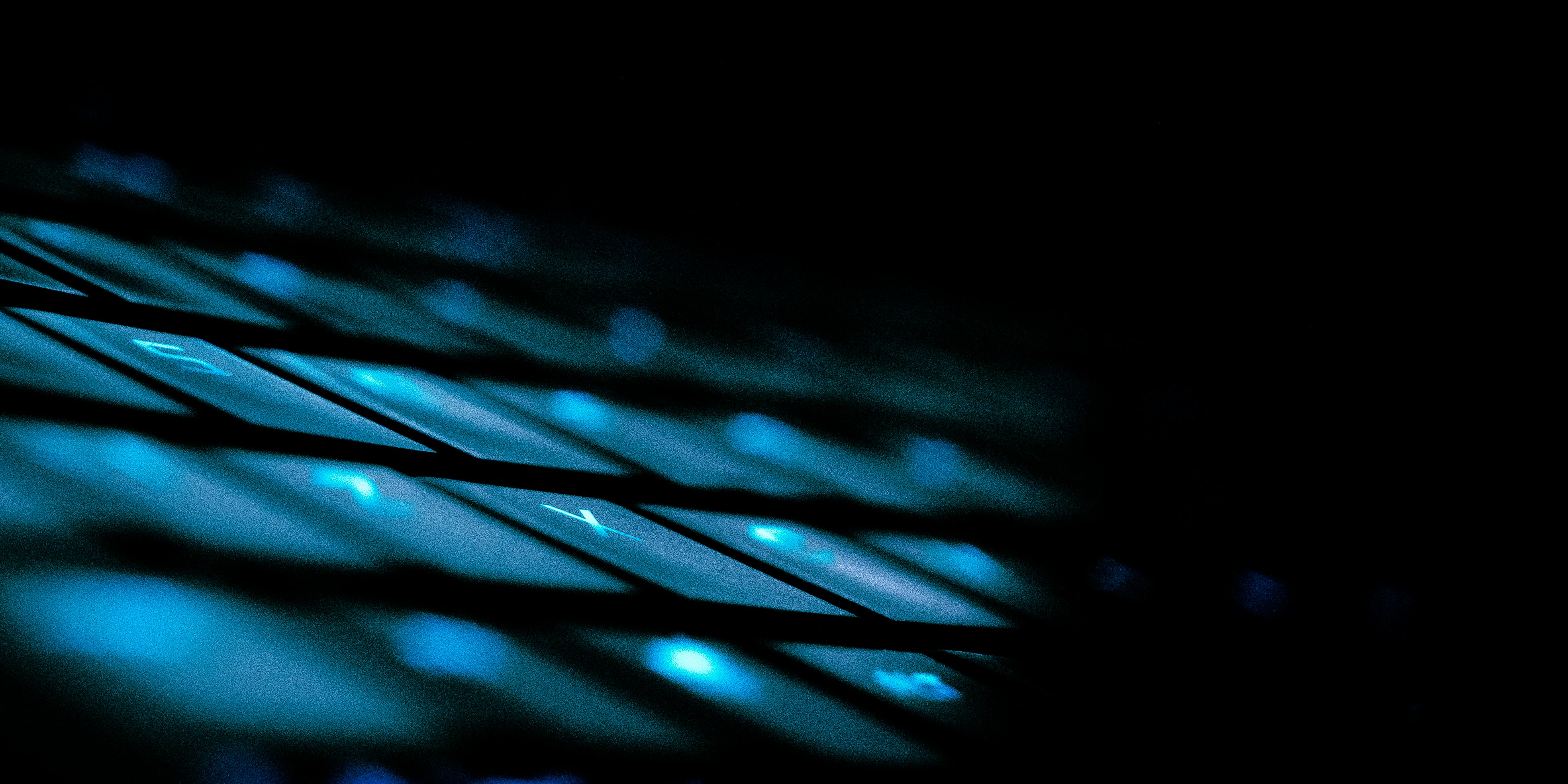 Close-up of a Hall Effect mechanical keyboard with RGB backlighting on a dark desk