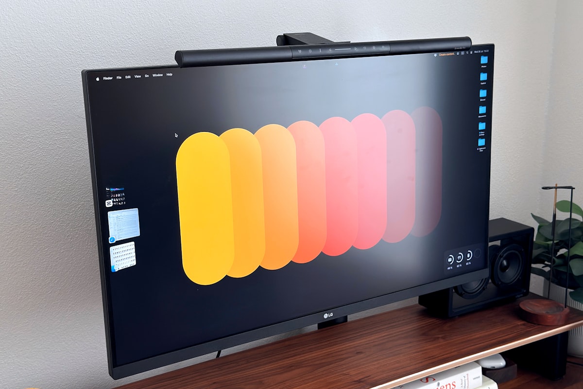 A desk setup with a computer monitor and keyboard resting on the desk surface