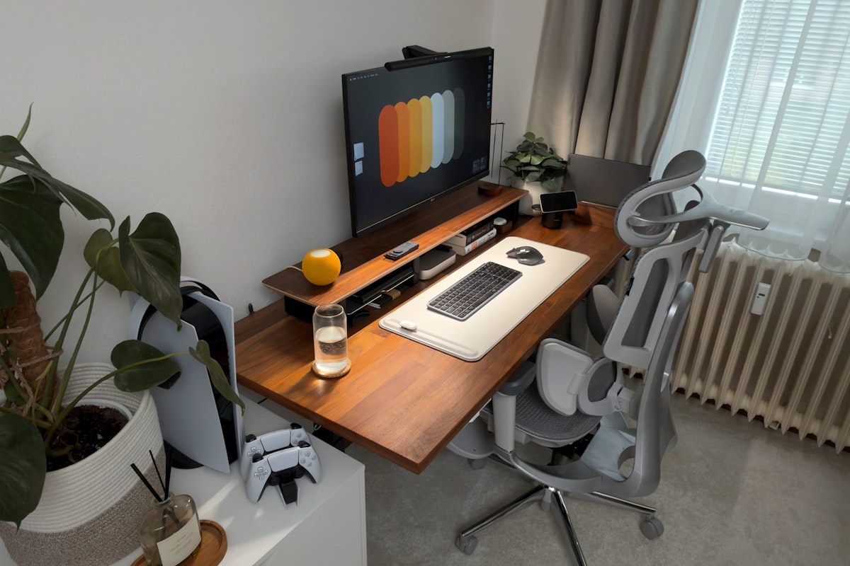A modern home office desk setup with a computer and chair