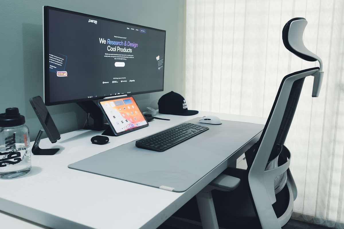 A modern desk setup with a computer and ergonomic chair
