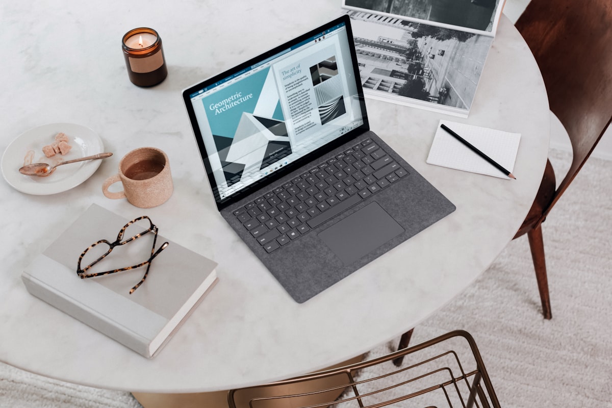 Multi-monitor arm setup with laptop tray and external display side by side