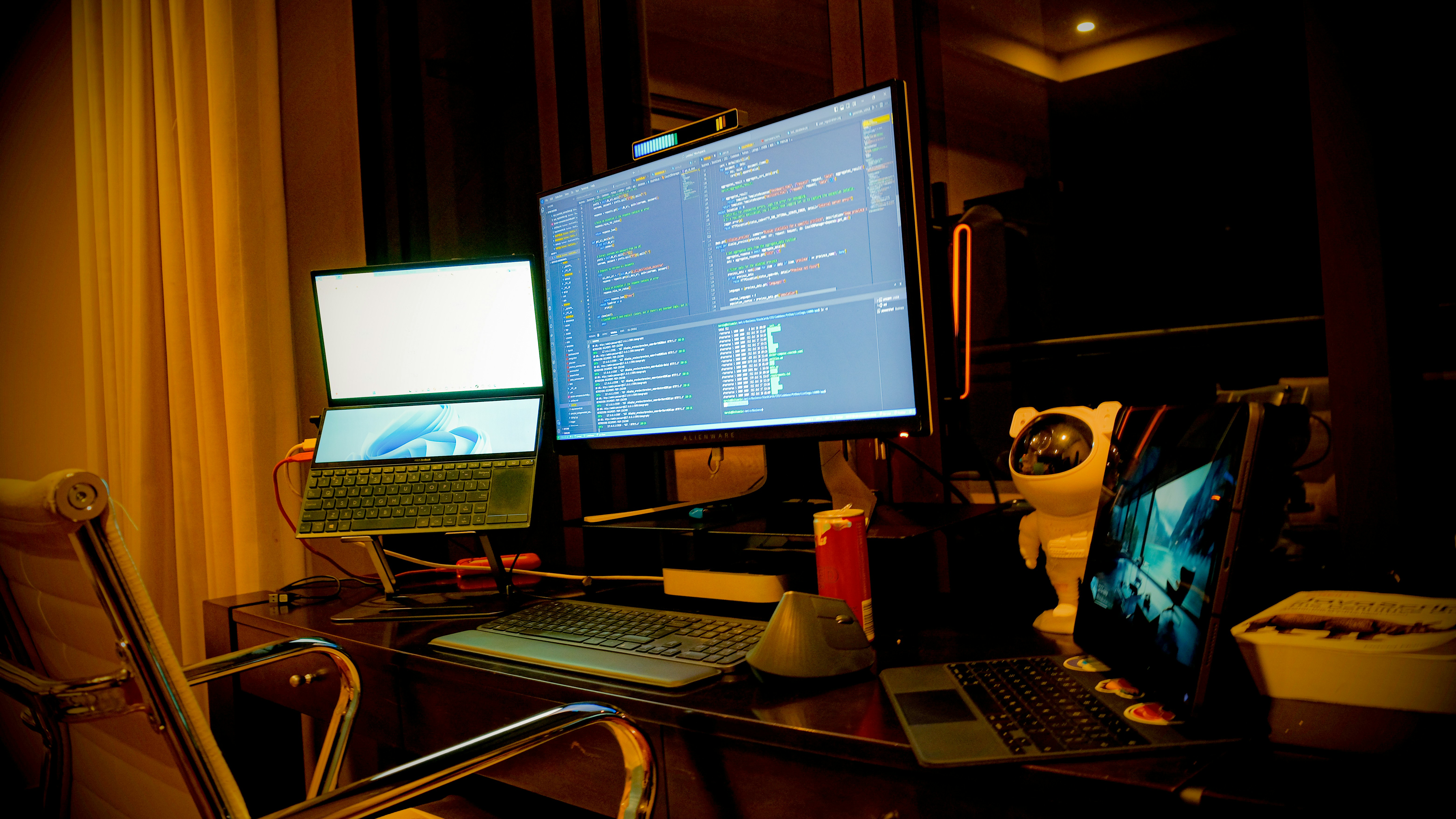 Dark dual-monitor workspace with ambient lighting