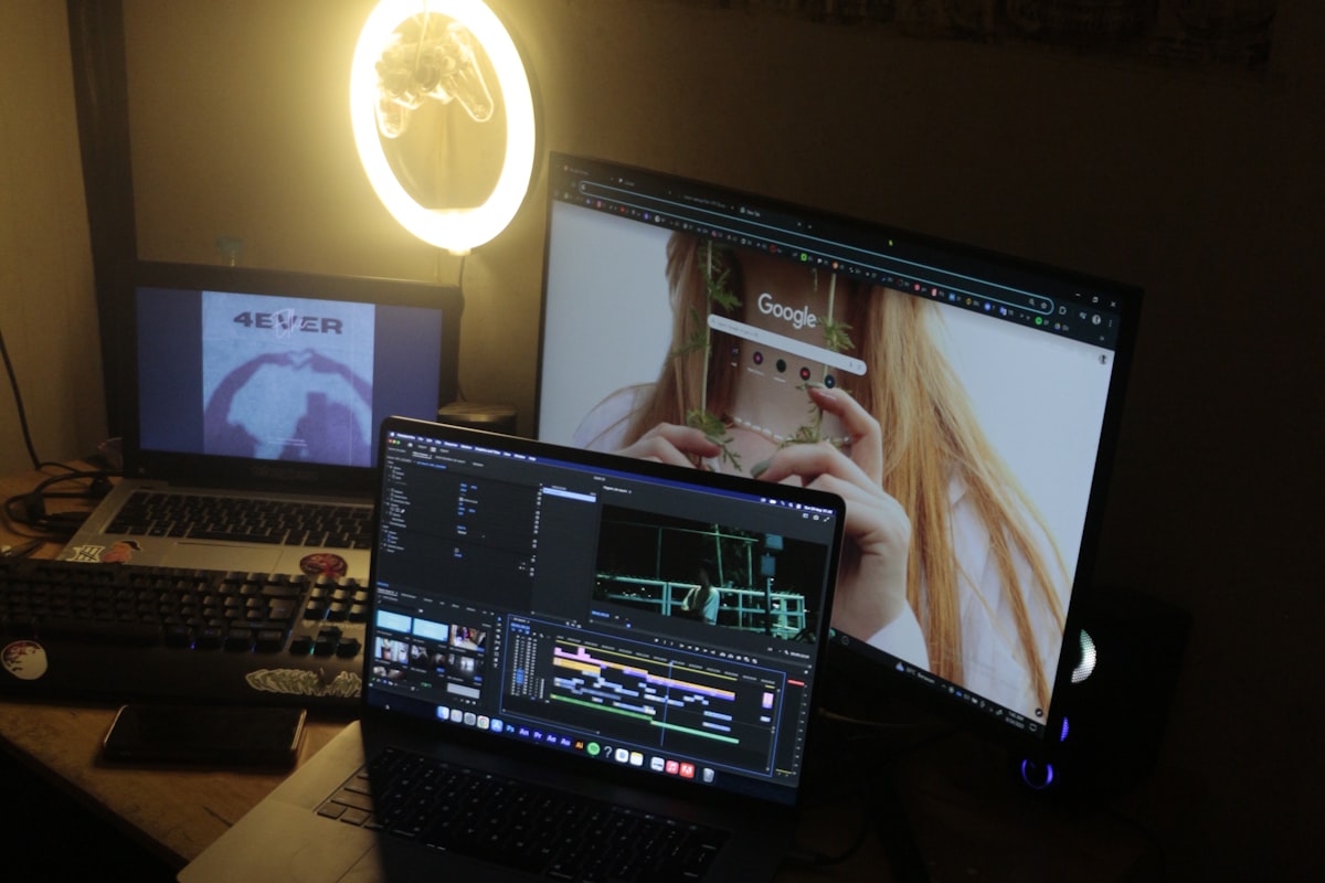 Dark-themed desk workspace with dual monitors and mechanical keyboard — a setup that benefits from standing desk converter flexibility