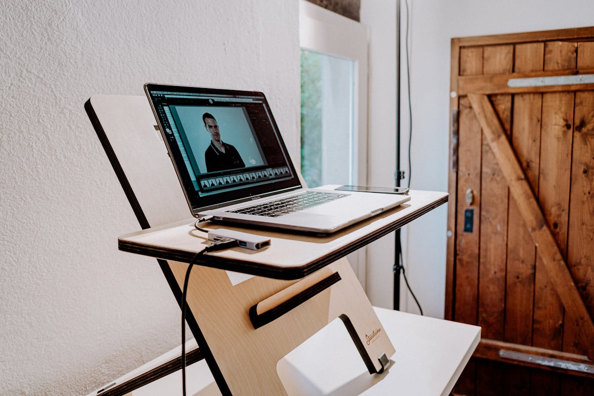 Wooden standing desk with modern minimalist setup and natural lighting