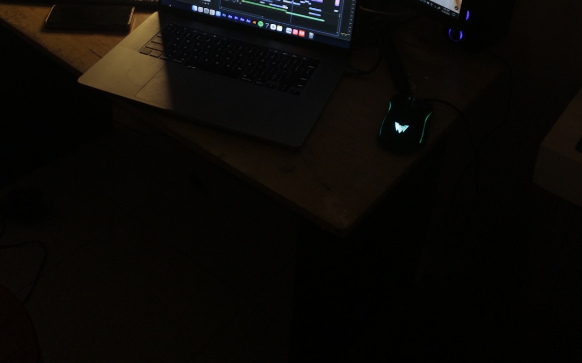 Dark-themed home office workstation with dual monitors and clean cable management, ample leg clearance for under-desk exercise equipment