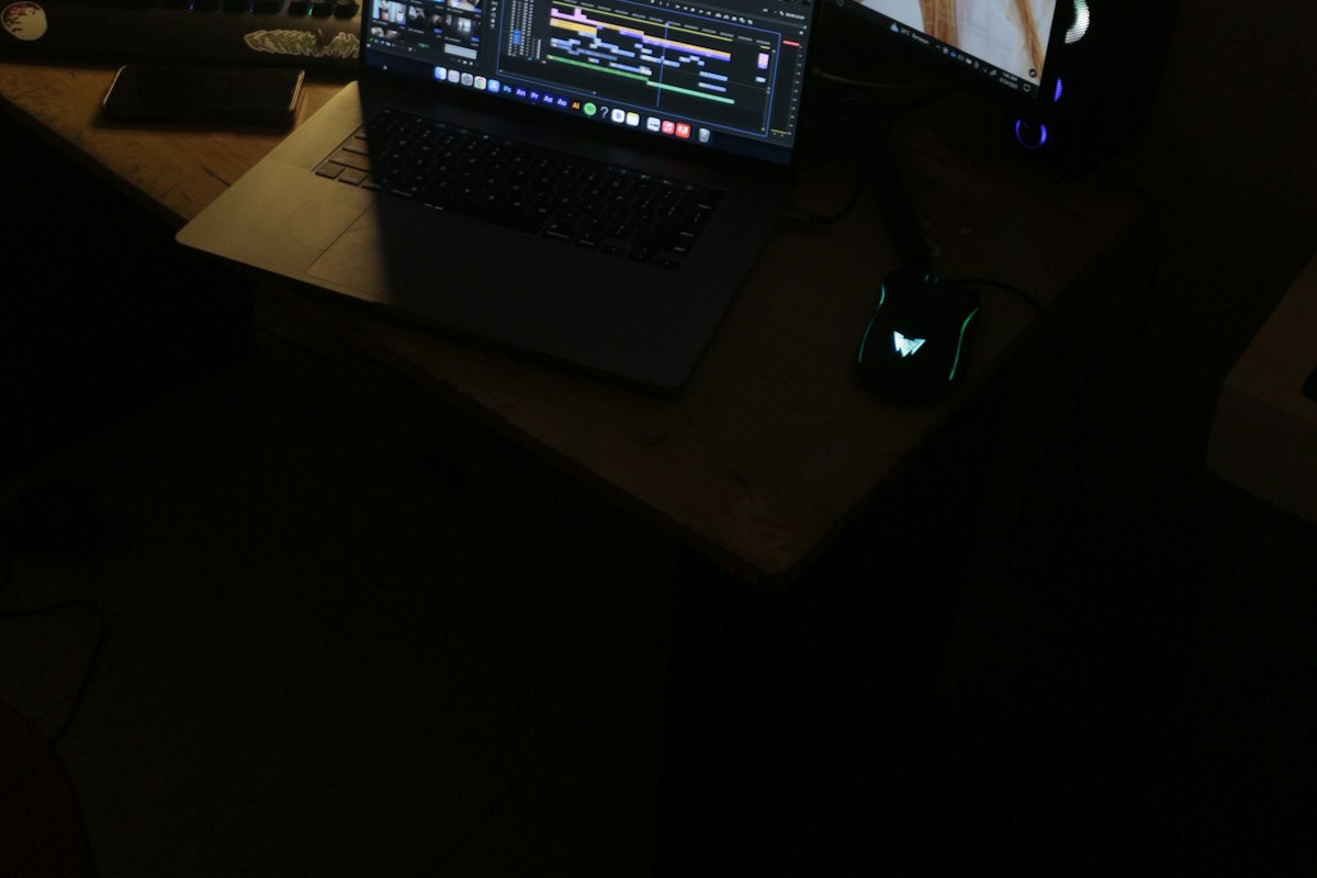 Person walking on an under-desk treadmill while working at a standing desk with dual monitors, showing the active workstation setup